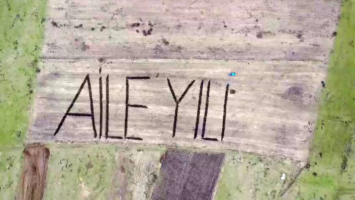 Tarlasına traktörüyle ‘Aile Yılı’ yazdı