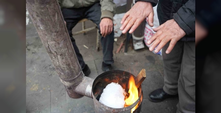 Erzincan pazarcısı soğukta sobayla ısınıyor